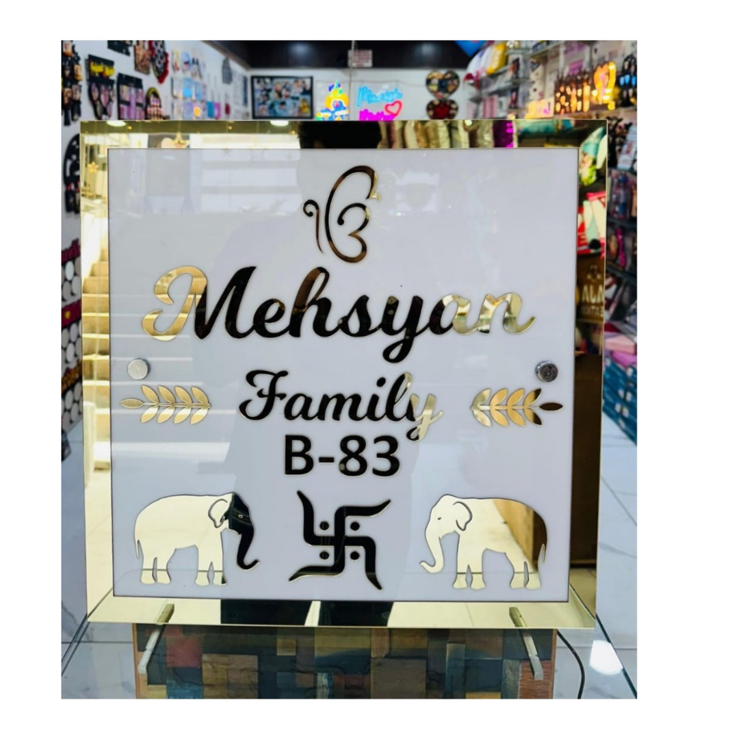White and gold acrylic family name plate displaying Mehsysar Family and house number B-83 with elephant and decorative motifs