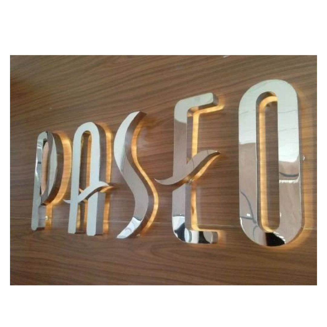 Raised silver mirror-finish 3D letters mounted on a wood-finish wall