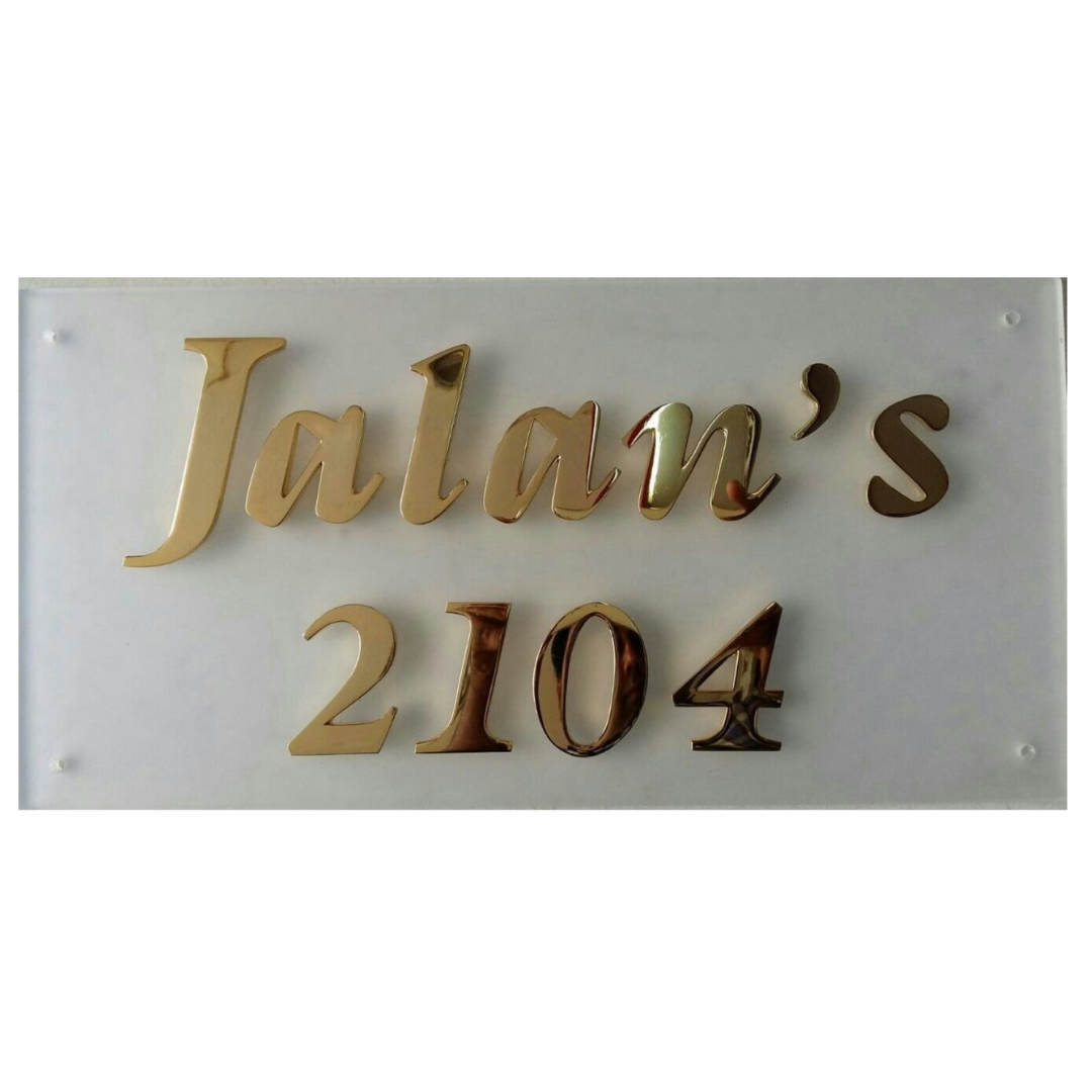 White acrylic name plate displaying Jatin’s 2104 in raised gold lettering