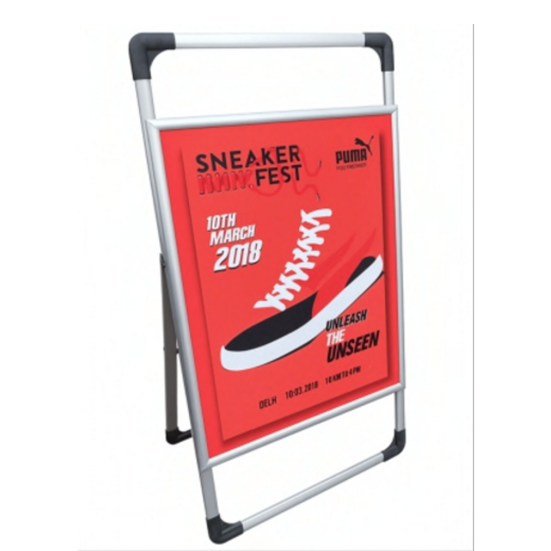 Red Puma Sneaker Fest promotional sign displayed on a freestanding A-frame stand.
