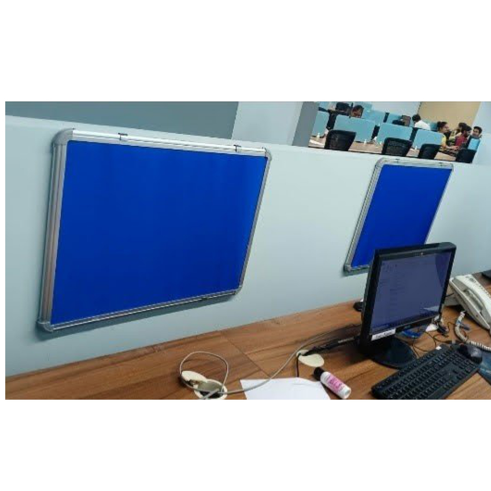 Blue fabric office partition notice boards with aluminium frames mounted on workstation cubicle panels for displaying memos, reminders, and office notices.