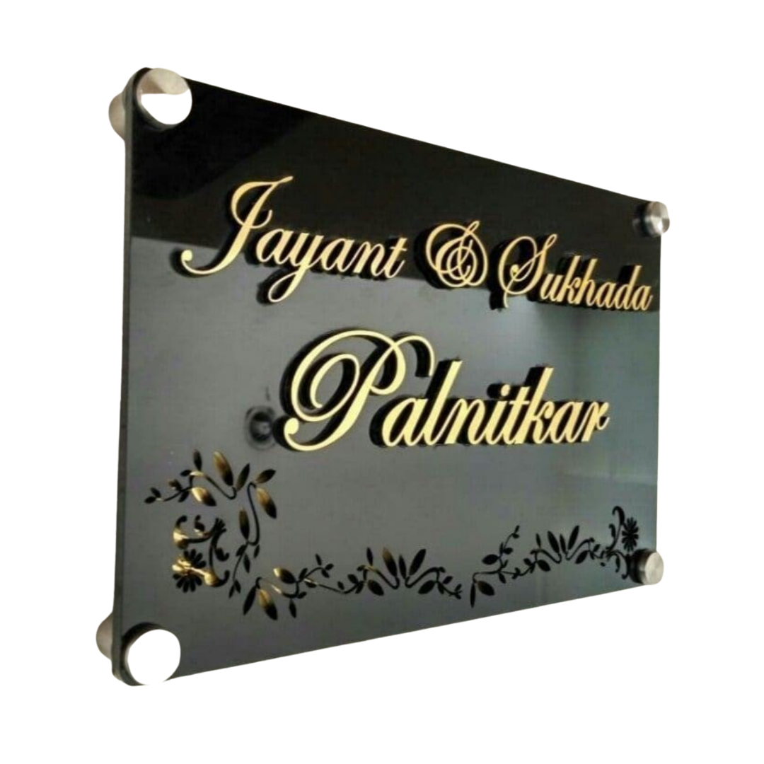 Black acrylic family name plate displaying Jayant and Sukhada Palnitkar in gold lettering with floral decoration