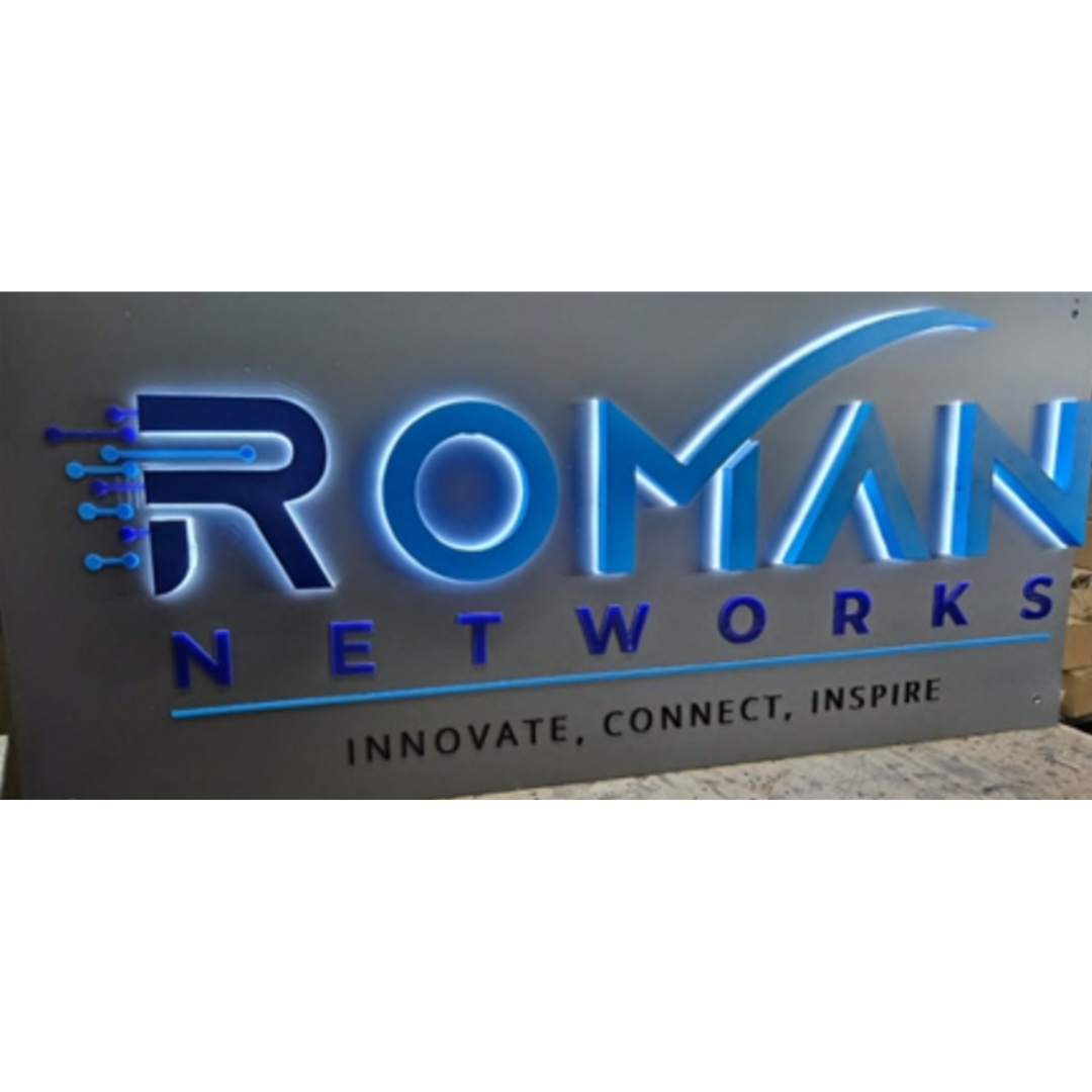 Blue illuminated 3D sign reading “ROMAN NETWORKS,” with a stylized digital logo and the tagline “INNOVATE, CONNECT, INSPIRE.”