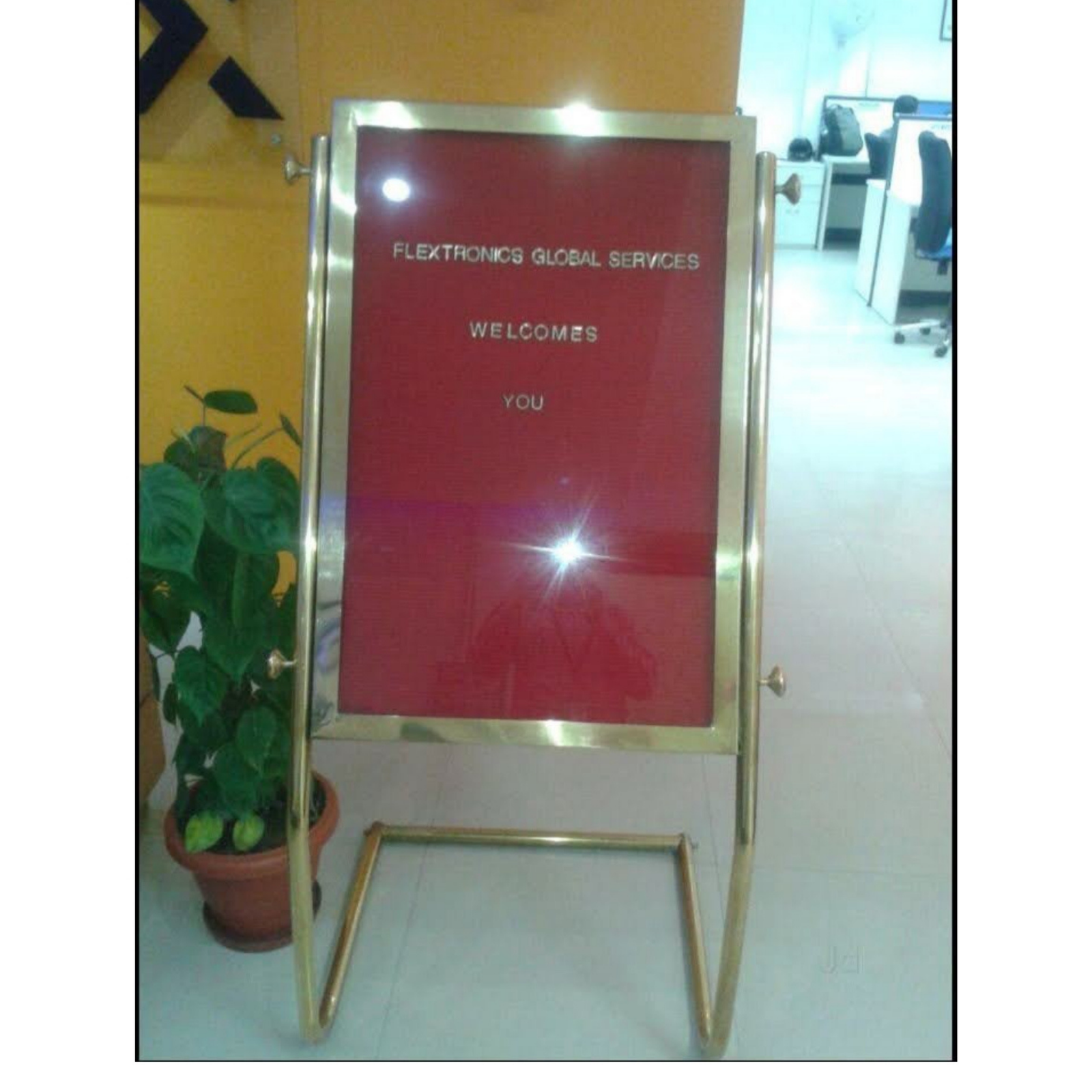 Premium stainless steel revolving letter board stand with a red felt grooved surface and interchangeable white letters, designed for displaying welcome messages, visitor information, and event schedules.