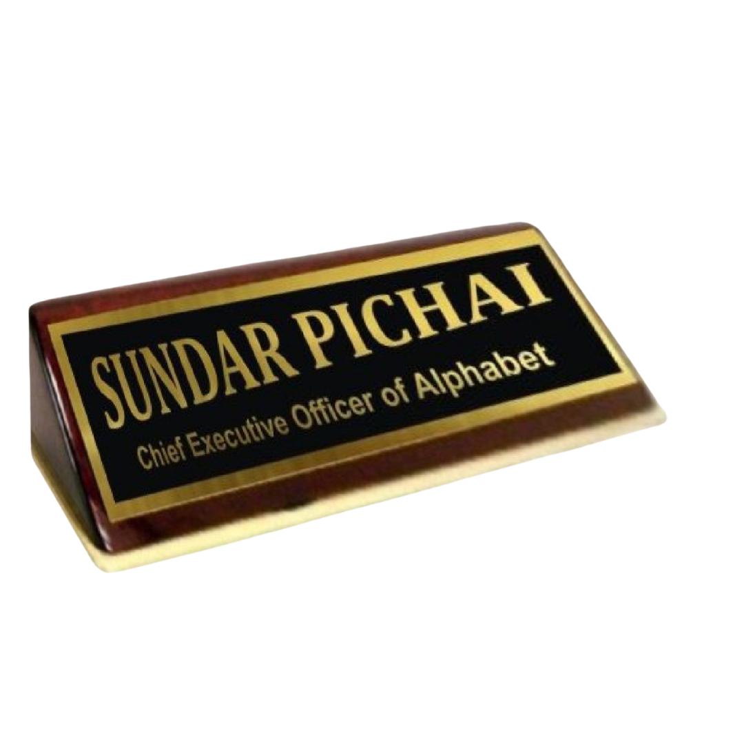 Wooden desk name plate displaying Sundar Pichai and Chief Executive Officer of Alphabet