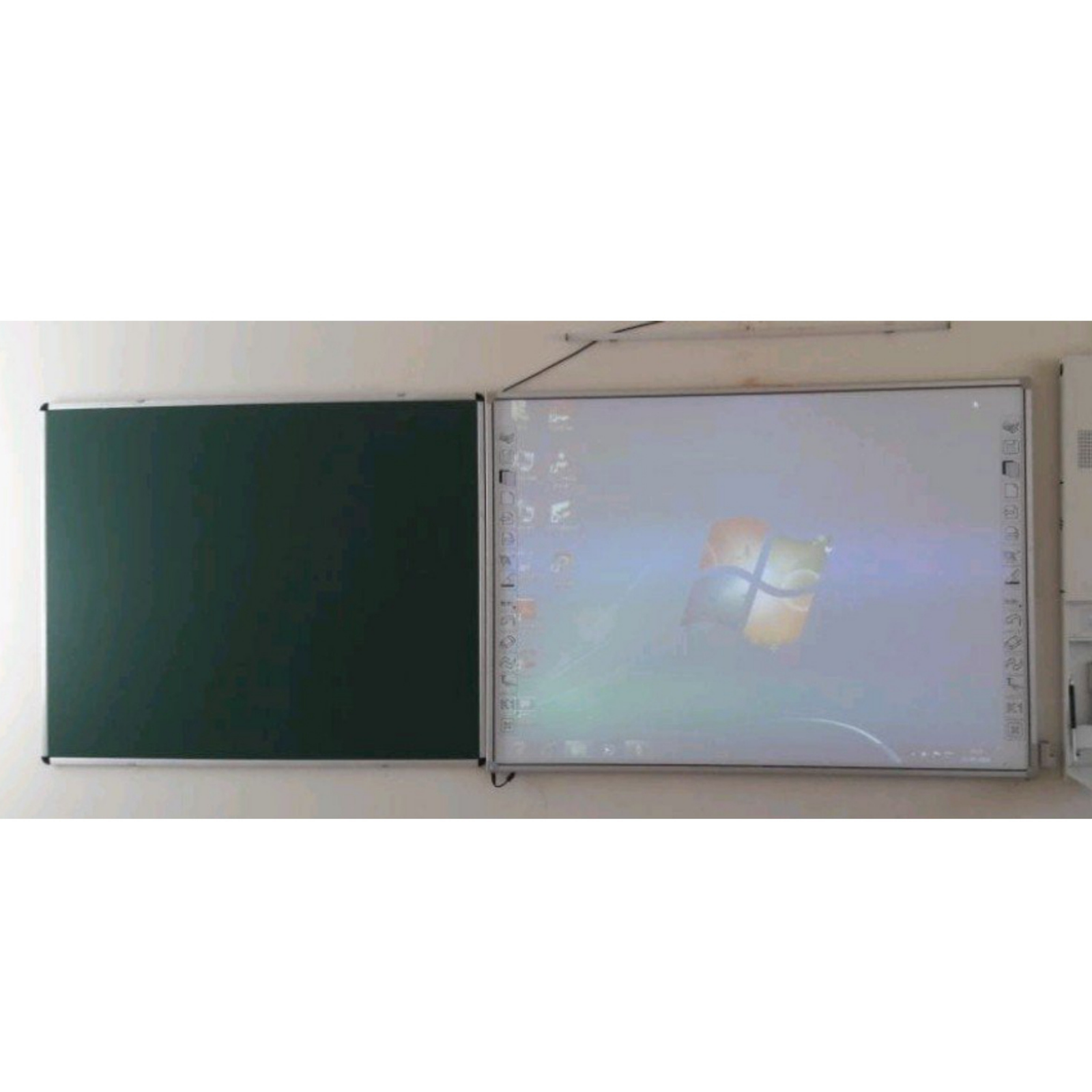 Elite Writing & Display green chalkboard installed beside an interactive whiteboard in a classroom for traditional and digital teaching.