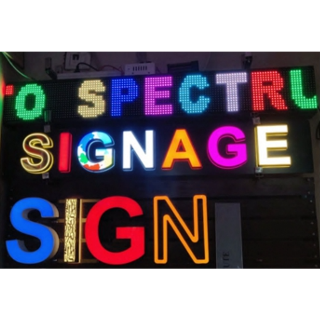 A display of colorful illuminated letters spelling “SPECTRUM,” “SIGNAGE,” and partially visible “SIGN,” with different lighting styles and colors.
