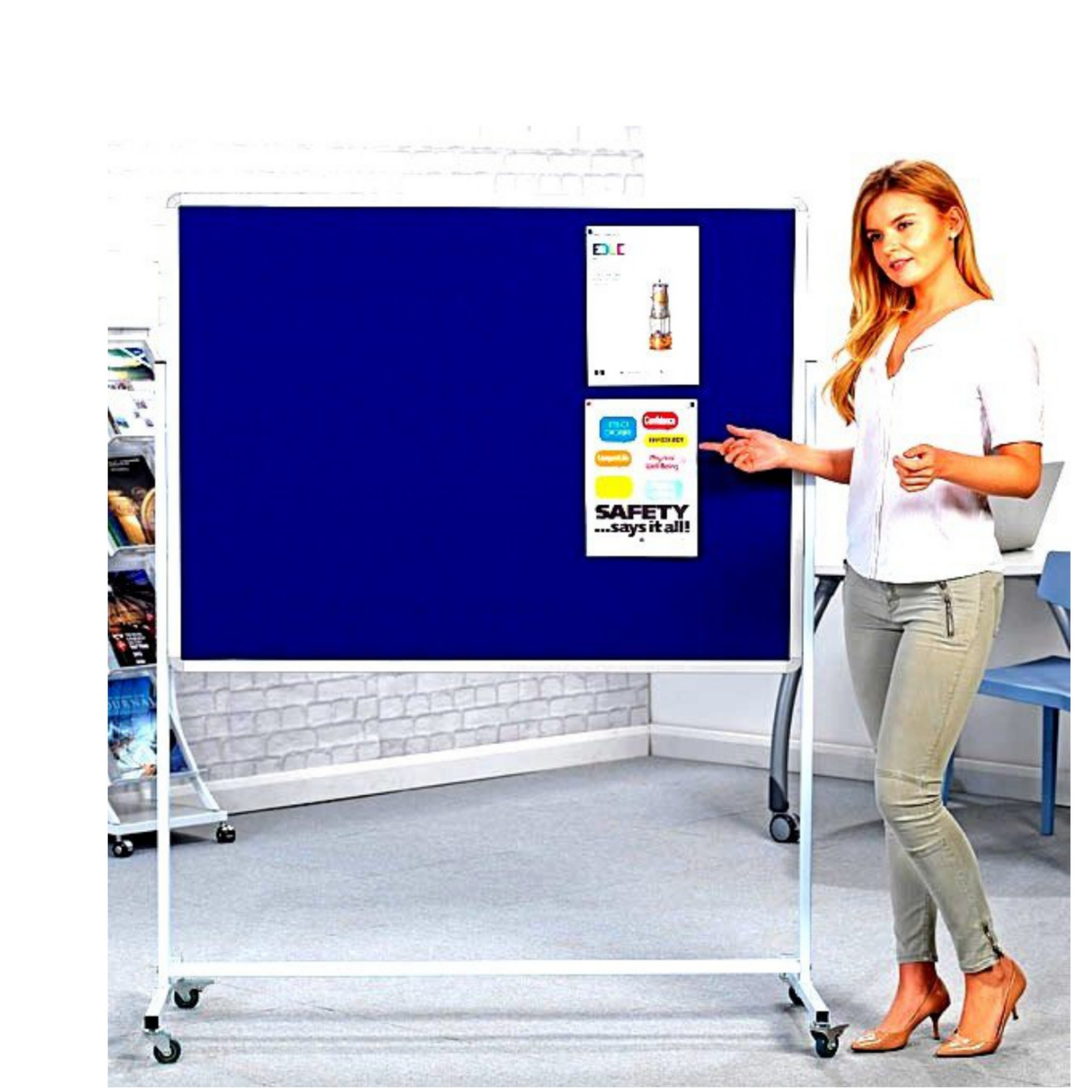 Elite Writing & Display mobile blue fabric notice board with aluminum frame and caster wheels, shown in an office setting beside a woman.