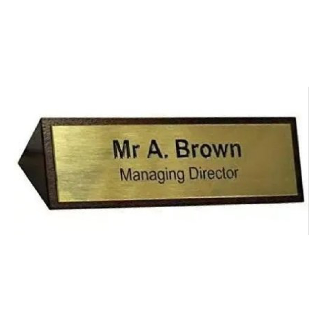 Wooden desk name plate with a gold-colored plaque reading “Mr A. Brown” and “Managing Director.”