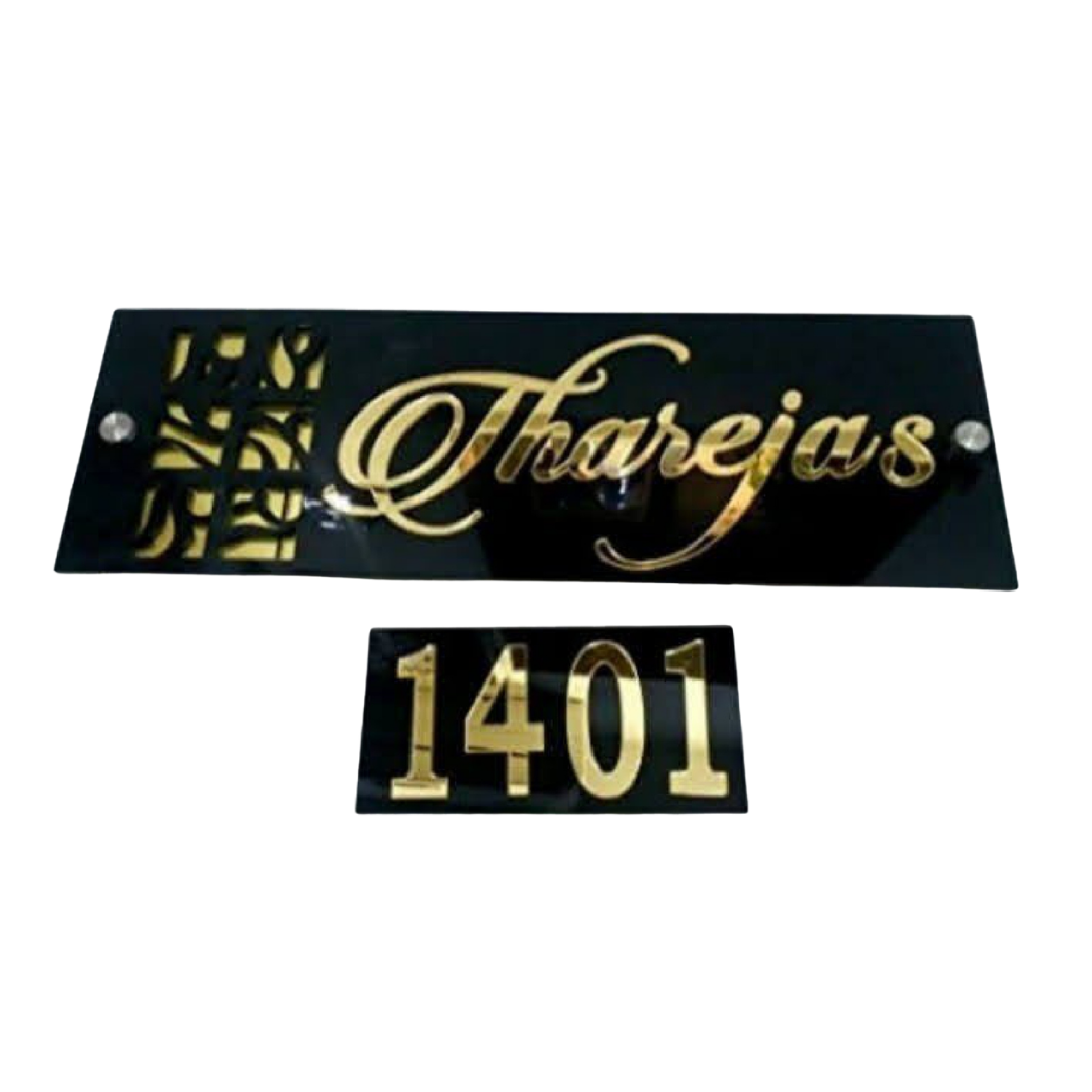 Black glossy name plate with gold cursive lettering reading “Tharejas” and a separate plaque displaying the number “1401.”