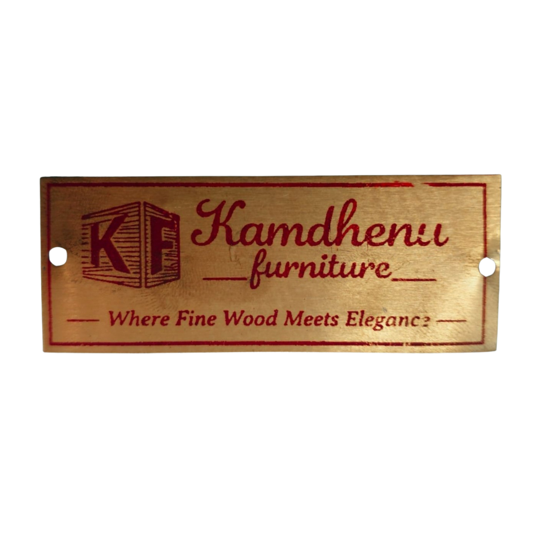 Rectangular wooden plaque reading “Kamdhenu Furniture” with a furniture logo and the tagline “Where Fine Wood Meets Elegance.”