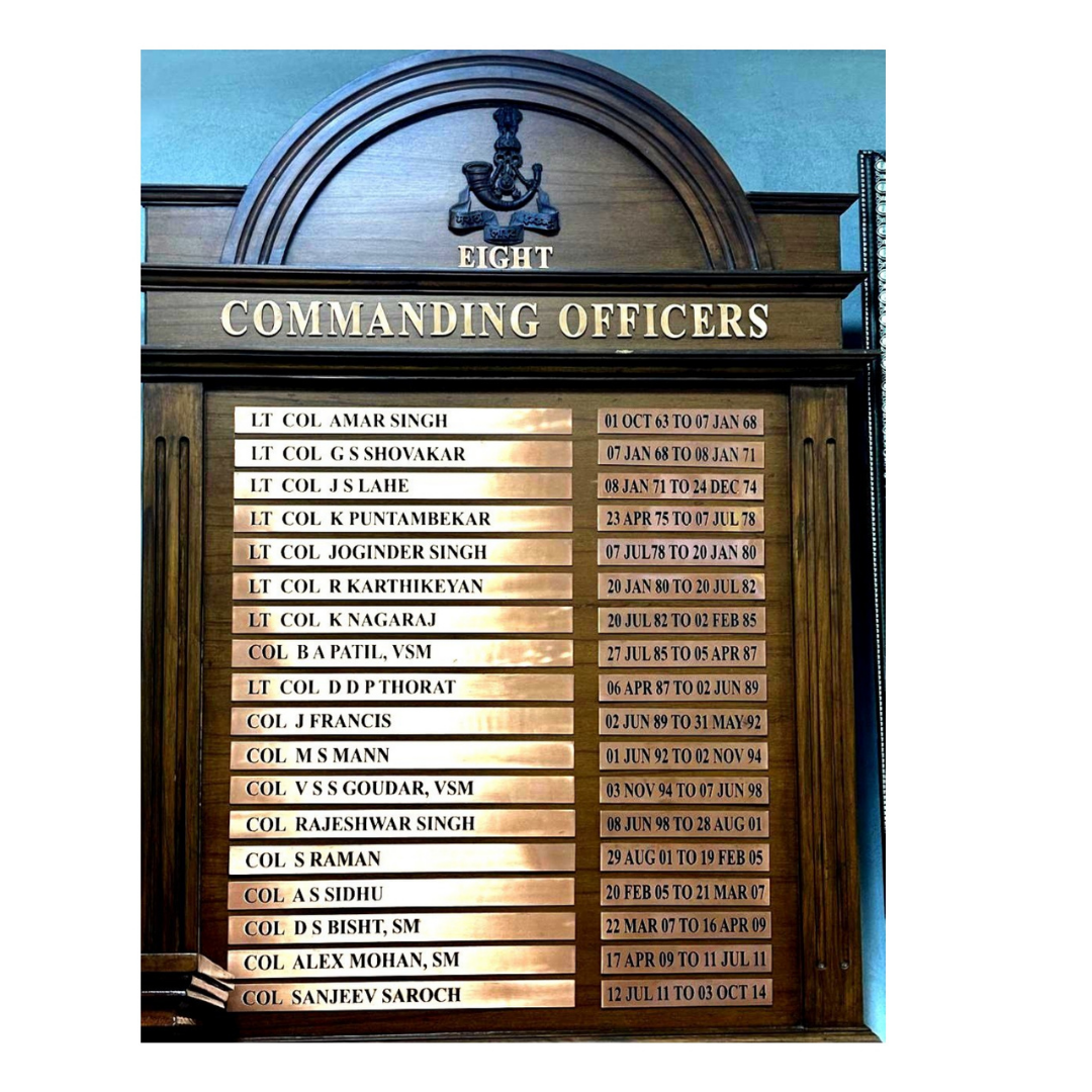 Wooden honor board displaying the commanding officers of Eight, with names and service dates.