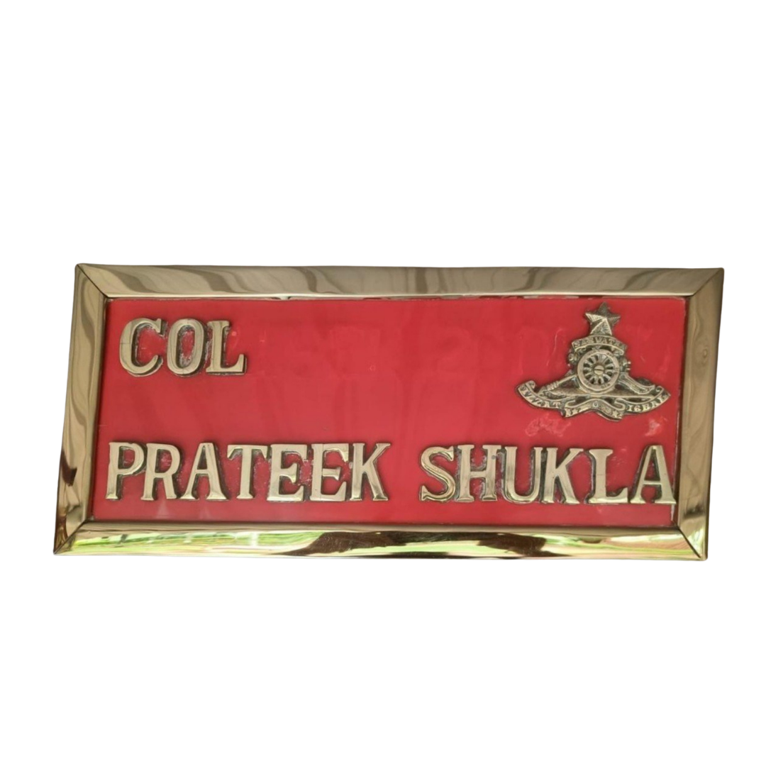 Customized red and gold military name plate displaying Col Prateek Shukla with an official emblem