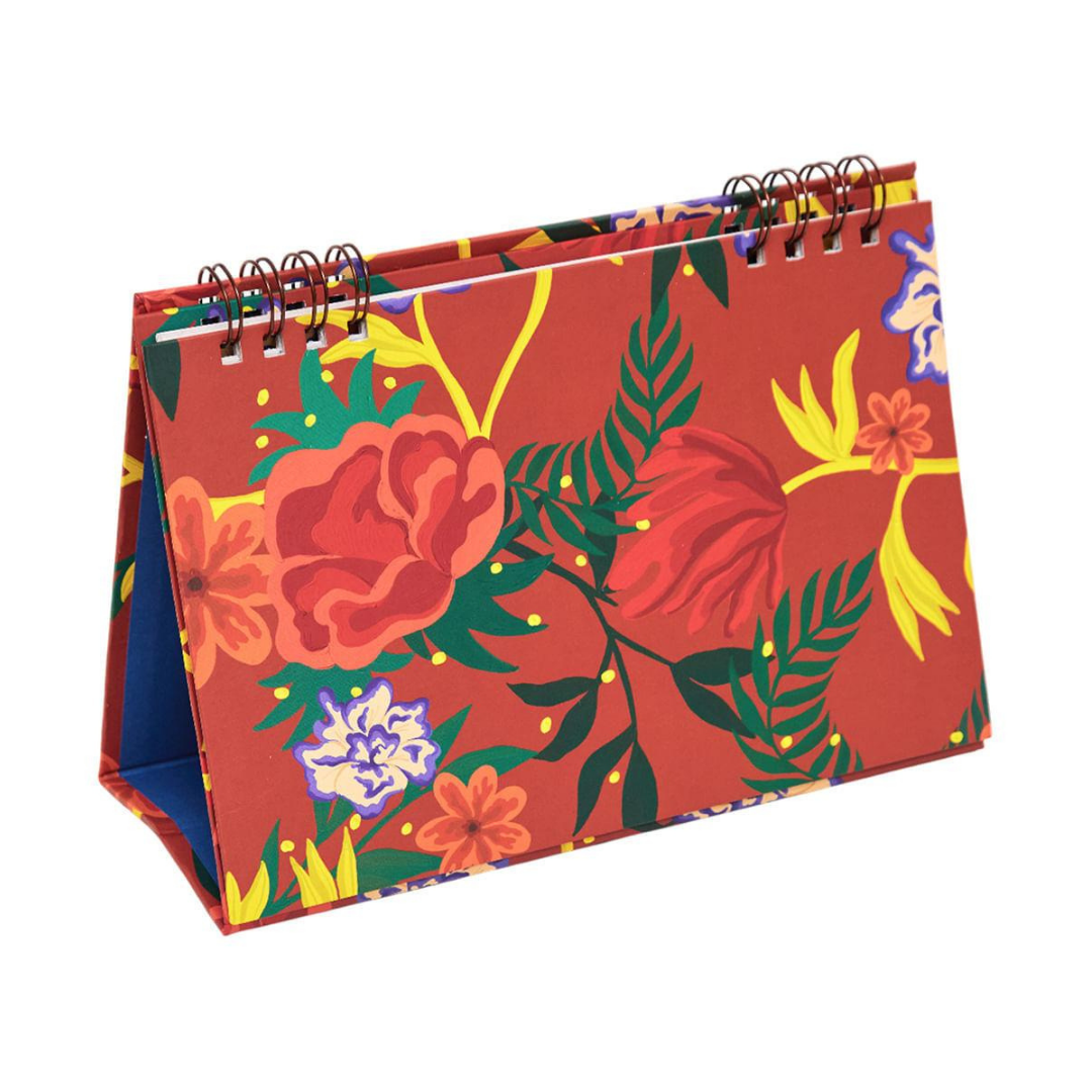 Red floral desk calendar with colorful botanical pattern and spiral binding