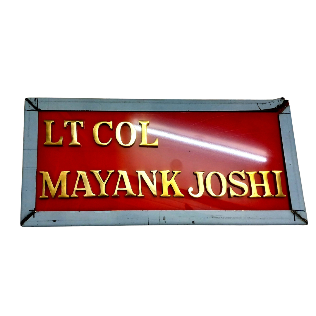 Customized red military name plate displaying Lt Col Mayank Joshi in raised gold lettering