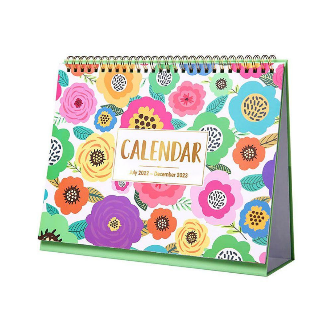 Colorful floral spiral-bound desk calendar on a green stand