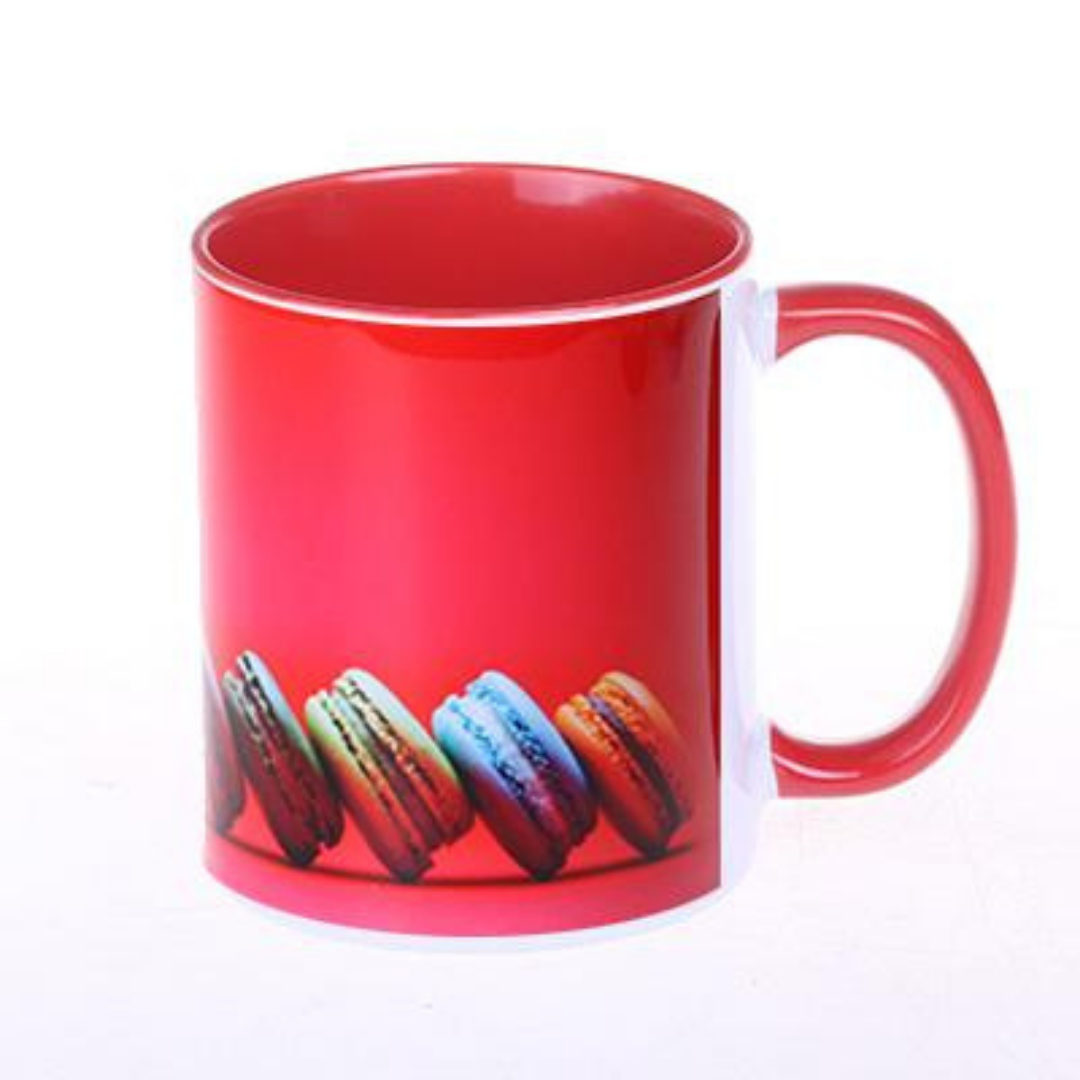 Red ceramic mug featuring colorful macarons printed along the bottom