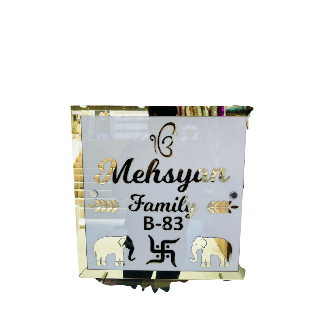 White and gold customized family name plate displaying Mehsysar Family and house number B-83