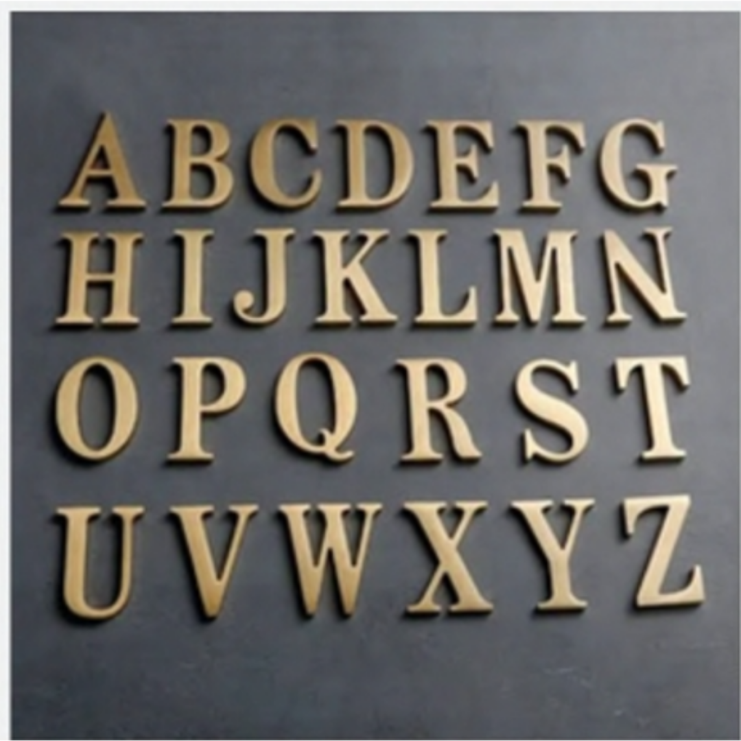 Gold and champagne-colored 3D uppercase alphabet letters A through Z displayed in rows on a dark gray background.