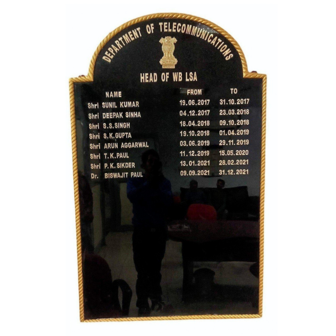 Black acrylic Head of WB LSA incumbency board displaying names and tenure dates of Department of Telecommunications officials